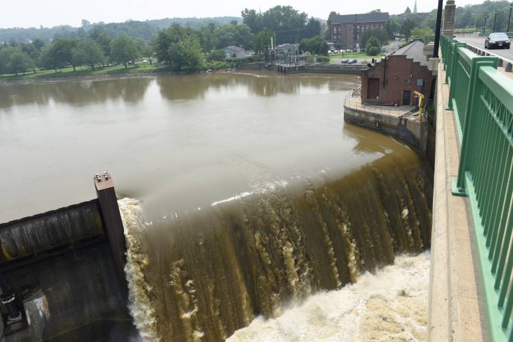 The brown water of the Connecticut River flows over the Turners Falls dam. The brown water of the Connecticut River flows over the Turners Falls dam.