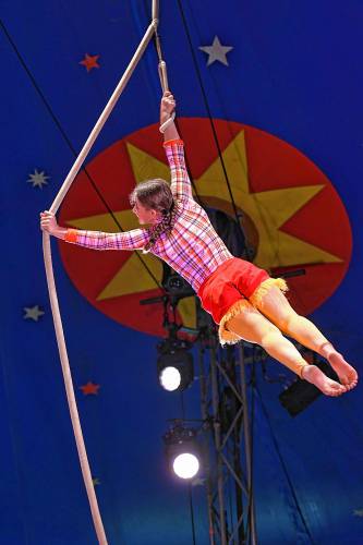 A performer spins on a rope high above the ring at a Circus Smirkus performance at the Franklin County Fairgrounds in Greenfield on Monday.