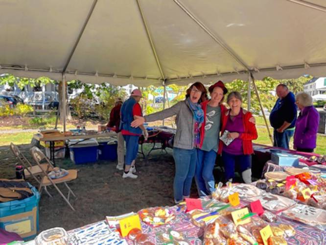 (From left) Ashley Parent , Michelle Sanger, and Gail Sullivan pose in the bake sale booth at the Festival of the Hills on Sunday. 