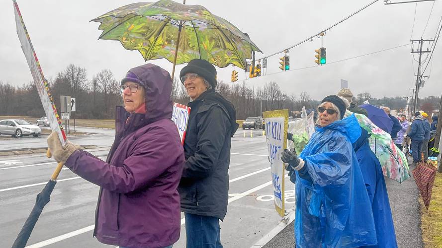 From left, Nancy Jessup and Betsy McNamara stand with protest organizer Marta Lev in Hadley on Monday to inform passing motorists about the recent probationary firings and office lease termination at the U.S. Fish & Wildlife Service.