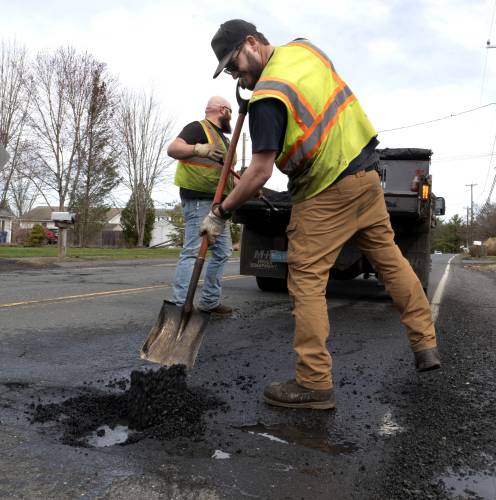 Adam Robbins and Tommy Cormier, employees of the Easthampton Highway Department, fill potholes on Florence Road earlier this month. Adam Robbins and Tommy Cormier, employees of the Easthampton Highway Department, fill potholes on Florence Road earlier this month.
