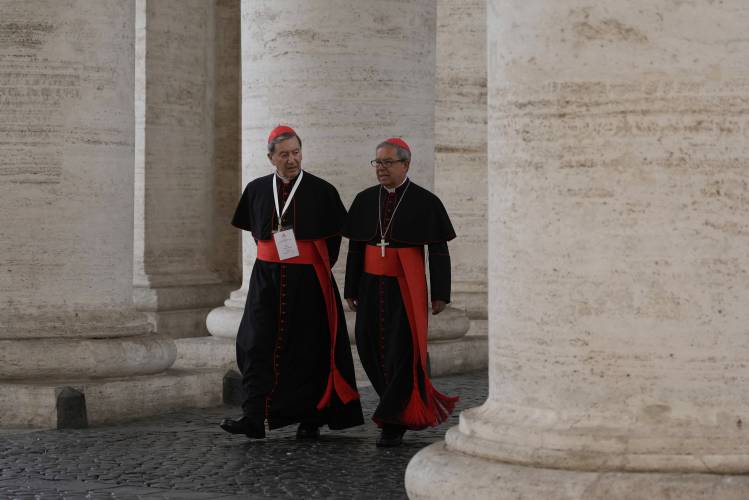 Cardinals Ruben Salazar Gomez, left is flanked by Cardinal Luis José Rueda Aparicio as they arrive in the New Hall of the Synod at the Vatican, Tuesday, May 6, 2025, the last time before the start of the conclave starting in the afternoon of Wenesday, May 7, when they will elect the successor of Pope Francis. (AP Photo/Gregorio Borgia)