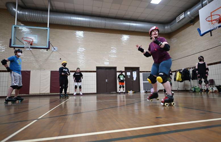 Caroline âBash-It Houndâ Moore of Northampton runs practice going over rules and techniques for participants of the Pioneer Valley Roller Derby at Franklin Countys YMCA in Greenfield. 