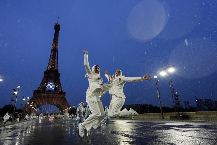 Egypt athletes leap while participating in the opening ceremony of the 2024 Summer Olympics, Friday, July 26, 2024, in Paris, France. (AP Photo/Andy Wong)