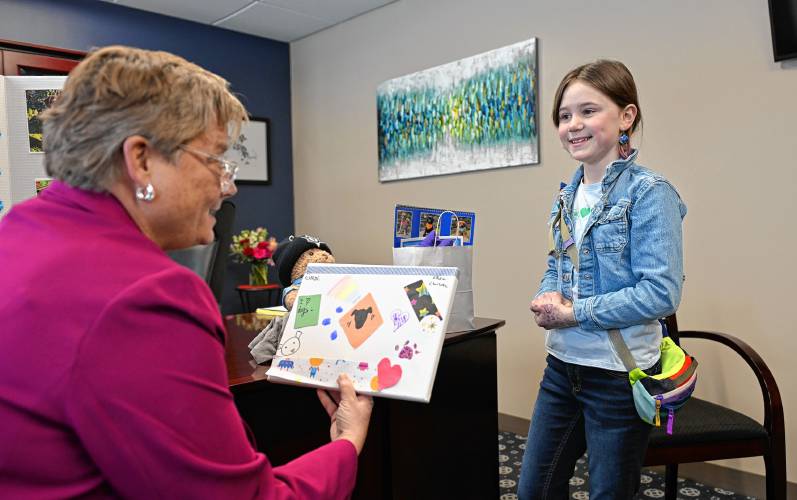 Interim Franklin County Sheriff Lori Streeter looks at artwork by Charlotte Cooley, 10, of Greenfield, who inspired a deluge of donations to the Franklin County Regional Dog Shelter after a post about her raising money for the shelter appeared online.