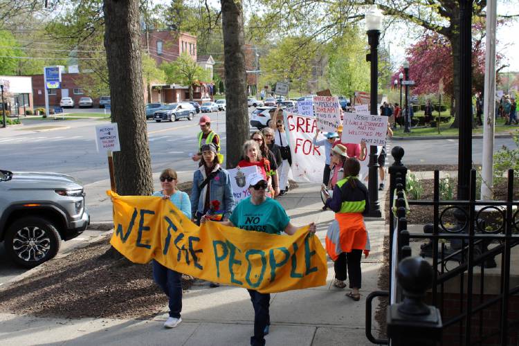 Crowds walk up Avenue A in Turners Falls as part of Thursday’s event, the “International Labor Day Bread and Roses Parade and Rally.”