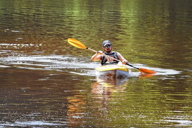 Bernardston resident Ian Lake kayaks along the Connecticut River to the Northfield Boat Ramp on Thursday.