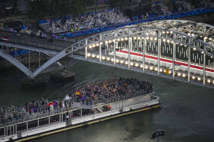 Athletes travel by boat down the Seine River in Paris, France, during the opening ceremony of the 2024 Summer Olympics, Friday, July 26, 2024. (AP Photo/Petr David Josek,Pool)