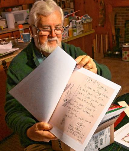 Peter Thomas shows a digitized letter that then 4-year-old Stacy Kubacki wrote to Santa Claus decades ago.
