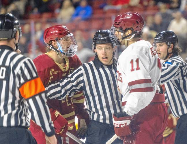 Boston College forward Mike Posma, left, and UMass center Lucas Mercuri, right, exchange words during the college hockey game at the Mullins Center, Saturday, Feb. 15, 2025, in Amherst.