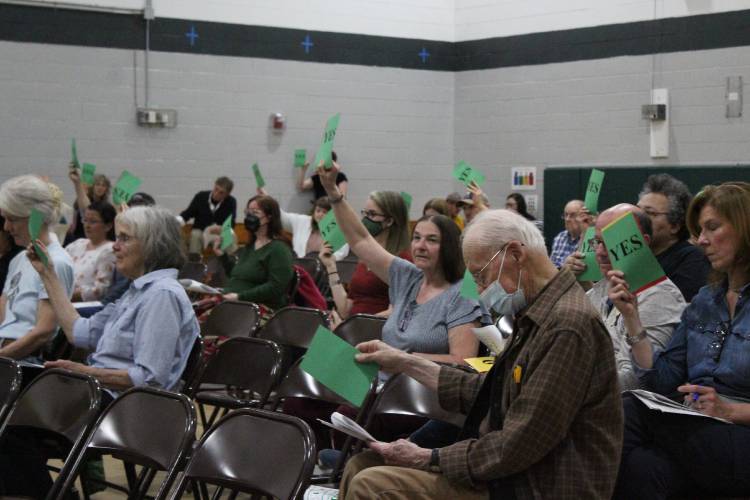 Sunderland residents vote to approve the fiscal year 2026 budget during Friday’s Annual Town Meeting at Sunderland Elementary School.