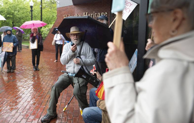 Bart Bouricius, of Montague Center, speaks during a protest in front of the Holyoke Heritage State Park Visitors Center before state officials gathered inside the building for a stakeholder meeting at which they took comment about clean energy siting regulations contained in the state’s new Climate Action Plan adopted last November. 