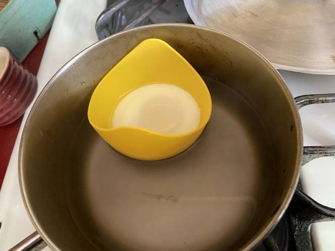 I poach my eggs using handy little silicone cups that hold them together in the boiling water. To use one of these silicone products, lightly oil the inside, pop your egg into it, and float the eggshell in a pot of boiling water.