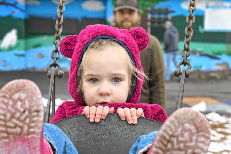 Sadie, 2½, hangs on as she is pushed on the swing by her father, Riley Baker, of Colrain, at Unity Park in Turners Falls on Friday afternoon. Sadie, 2½, hangs on as she is pushed on the swing by her father, Riley Baker, of Colrain, at Unity Park in Turners Falls on Friday afternoon.
