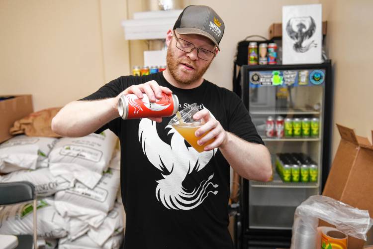 Errin Woessner of Freedom Street Brewery in Erving pours a double IPA called Revive.