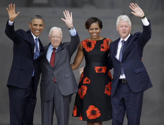 From left, President Barack Obama, former President Jimmy Carter, first lady Michelle Obama and former President Bill Clinton wave to the crowd from the steps of the Lincoln Memorial in Washington at the conclusion of a ceremony to commemorate the 50th anniversary of the 1963 March on Washington for Jobs and Freedom, Aug. 28, 2013.