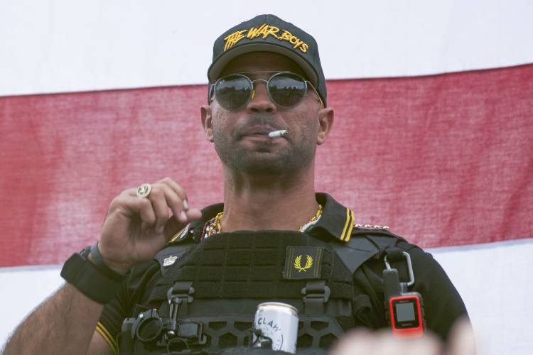 Former Proud Boys leader Henry “Enrique” Tarrio wears a hat that says The War Boys during a rally in Portland, Ore., on Sept. 26, 2020.