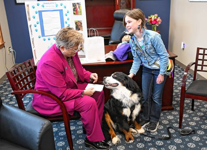 Interim Franklin County Sheriff Lori Streeter and comfort dog Lucky meet with Charlotte Cooley, 10, of Greenfield, who inspired a deluge of donations to the Franklin County Regional Dog Shelter after a post about her raising money for the shelter appeared online.