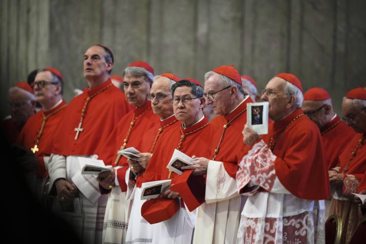 Cardinal Luis Antonio Tagle, center, takes part in the procession carrying the body of Pope Francis to St. Peter's Basilica at the Vatican, Wednesday, April 23, 2025, where he will lie in state for three days. (AP Photo/Alessandra Tarantino, File)