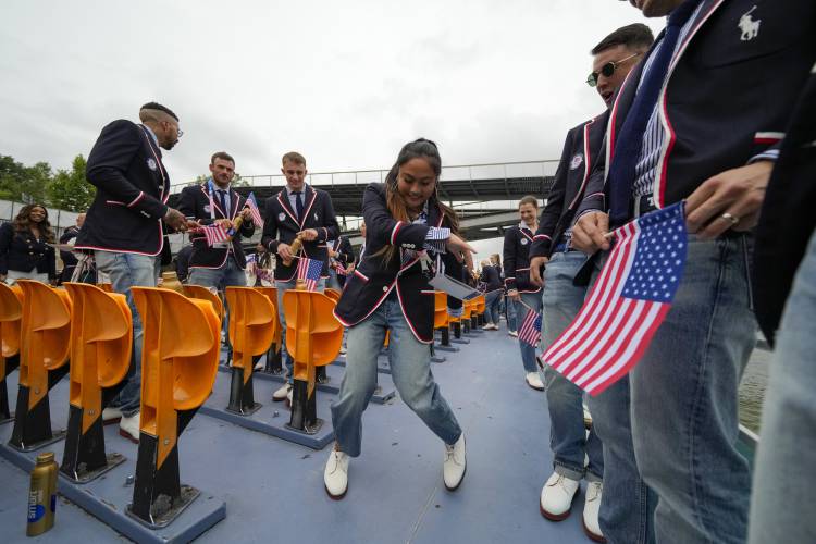 Logan Edra, of the United States breakdancing team, dances as she travels along with teammates on the Seine River in Paris, France, during the opening ceremony of the 2024 Summer Olympics, Friday, July 26, 2024. (AP Photo/Ashley Landis, Pool)