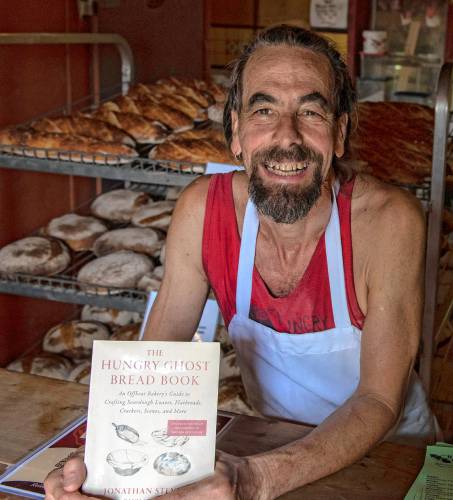 Jonathan Stevens with “Hungry Ghost Bread Book,” which will be released Sept. 5. The bakery plans to celebrate their 20th anniversary and the book’s publication at its “quasi-annual Wonder Not! Bread Festival” on Sunday, Sept. 29, from 11 a.m. to 5 p.m. in and around the bakery at 62 State St.