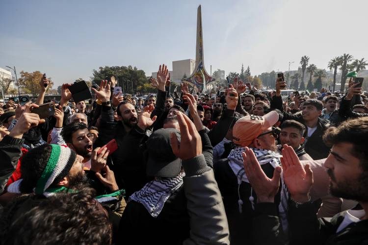 Syrians celebrate the ouster of the Assad regime Monday at Omayyad Square in Aleppo, Syria. Syrians celebrate the ouster of the Assad regime Monday at Omayyad Square in Aleppo, Syria.