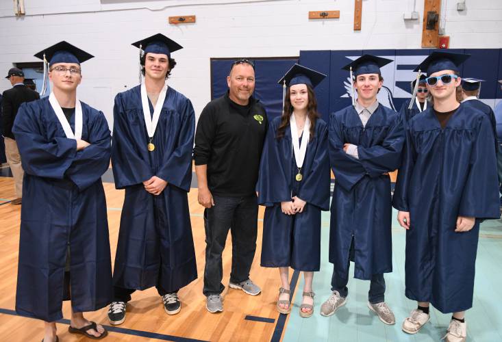 Franklin County Technical School Student Resource Officer Michael Sevene, center, poses with students for a picture before graduations ceremonies in Montague on Thursday evening.