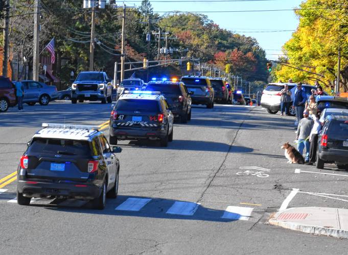 Montague Police Officer James Ruddock and the cremated remains of his K-9, Artie, return to Montague after a police motorcade escorted them from the Pioneer Valley Veterinary Hospital in Greenfield to the Montague Public Safety Complex on Tuesday morning. 