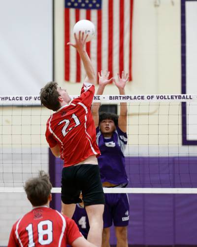 Athol’s Jack Waslaske (21) hits at the net against Holyoke in the first set  in Holyoke last spring. 