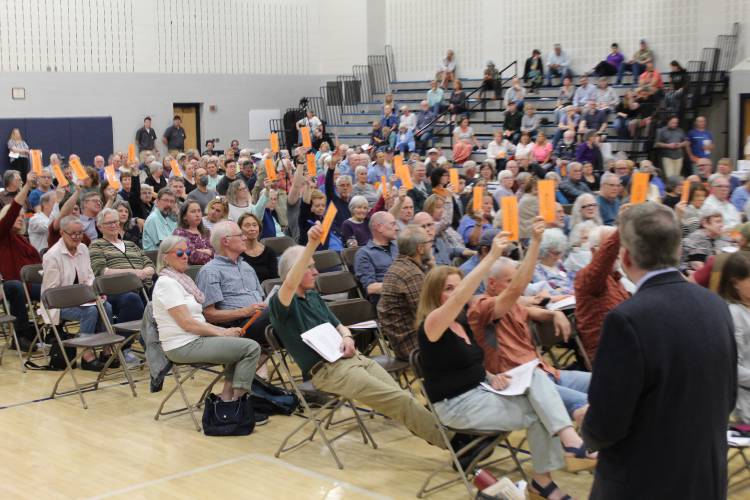 Deerfield Town Moderator Dan Graves counts votes at Monday’s Annual Town Meeting at Frontier Regional School for a citizen’s petition that sought to lower Deerfield’s municipal voting age to 16. The measure was voted down, after a ballot count was requested, 107-194.