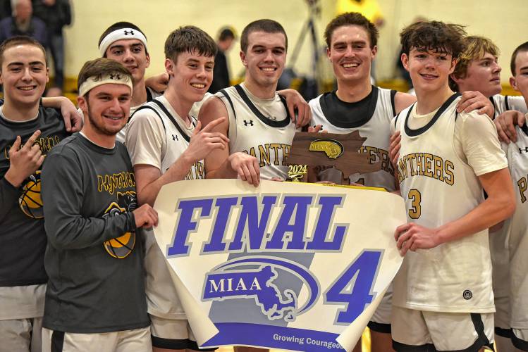 Members of the Pioneer boys basketball team hold up the Final Four banner after defeating Drury 54-44 in the MIAA Division 5 quarterfinal round on Saturday at Messer Gymnasium in Northfield.