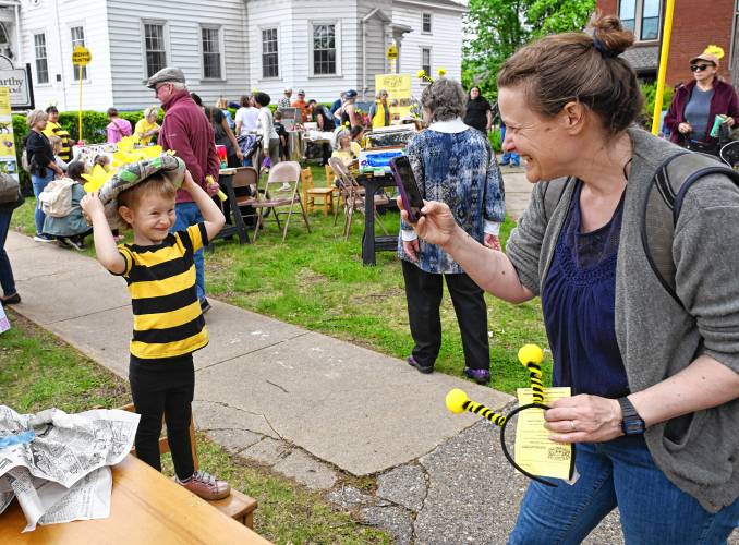 Sonia Oppenhiem, right, takes a picture of her 3-year-old daughter Myra in her festive hat they created at the 14th Annual Bee Fest in Greenfield Saturday. 