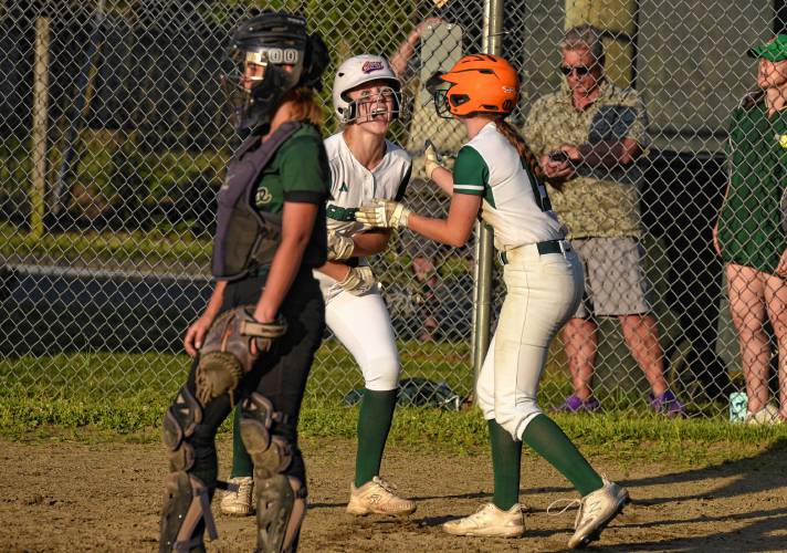 Greenfield’s MacKenzie Paulin, left, and Anna Bucala celebrate after scoring runs to tie the game in the bottom of the sixth inning during the MIAA Division 5 quarterfinal against Tahanto on Friday at Vets Field in Greenfield.