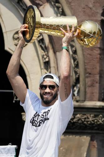 Boston Celtics' Jayson Tatum celebrates the team's NBA basketball championship during a duck boat parade Friday, June 21, 2024, in Boston. (AP Photo/Michael Dwyer)