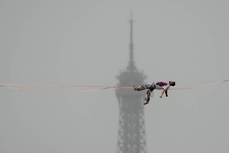 A tight rope walker performs in Paris, France, during the opening ceremony of the 2024 Summer Olympics, Friday, July 26, 2024. (AP Photo/Aaron Favila)