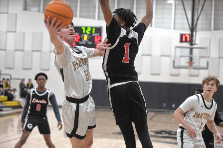 Pioneer's Brayden Thayer tries to get a layup off around Libertas Academy's Ron Jones during a quarterfinal contest of the Western Mass. Class D Tournament at Messer Gymnasium Monday. 