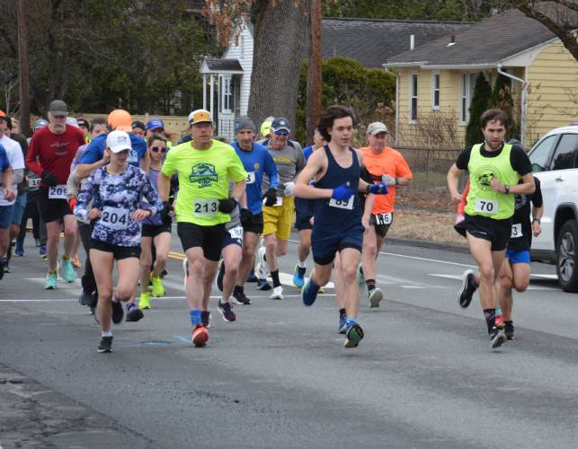 Runners take off at the start of the Ron Hebert Road Race last weekend.  Mark Rabasco (bib 70) and Kayla Gladu (204) won the men’s and women’s divisions, respectively.