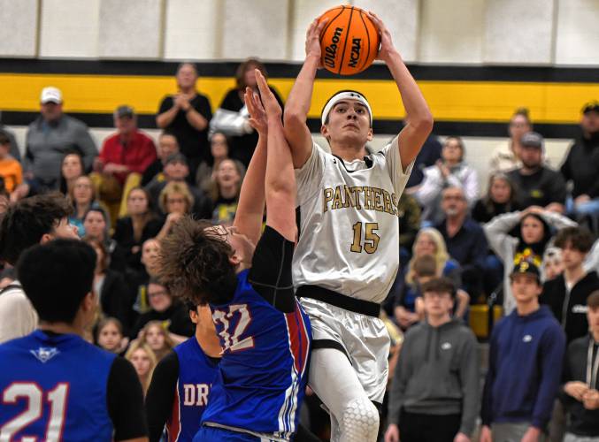 Pioneer’s Alex McClelland (15) goes to the basket while defended by Drury’s Connor Hinkell (32) during the Panthers’ 54-44 victory in the MIAA Division 5 quarterfinal round on Saturday at Messer Gymnasium in Northfield.