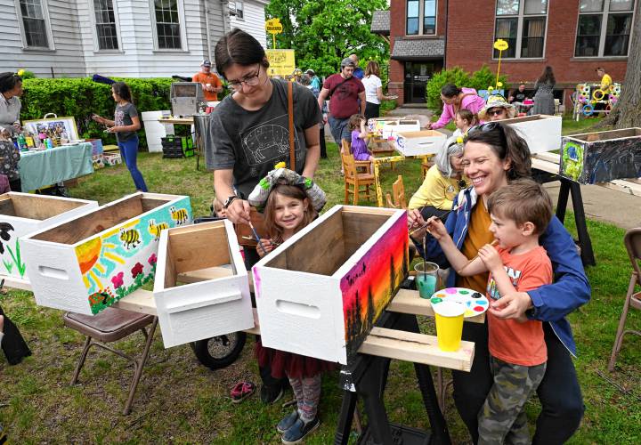 Adults and children paint bee hives at the 14th Annual Bee Fest in Greenfield Saturday. 