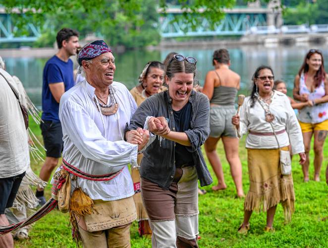 John “Jim” Peters Jr., executive director of the Massachusetts’ Commission on Indian Affairs, left, dances with New Salem resident Anya Klepacki during the Pocumtuck Homelands Festival, celebrating Native American art, music and cultures at Unity Park in Turners Falls on Saturday.