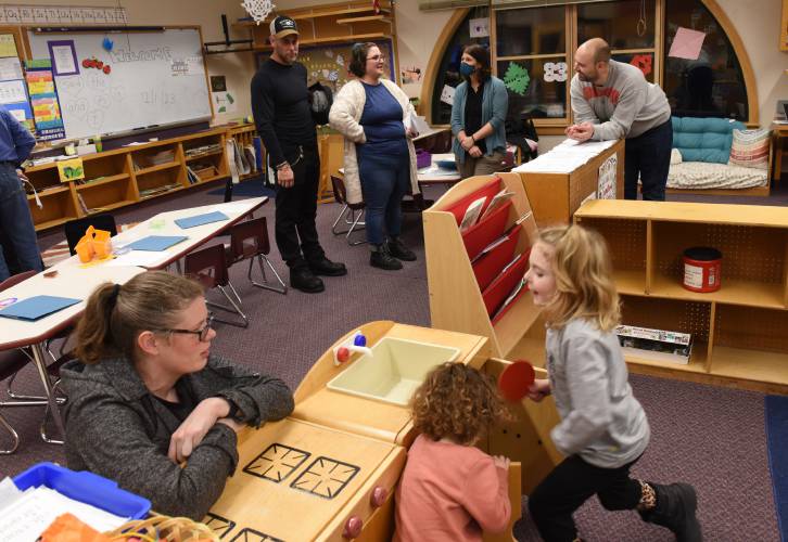 Warwick Community School staff members Stephanie Cross, at lower left, and Carlene Murray, with mask, speak with parents and students during an open house at the school in December 2023. Just one year after it reopened its doors to students in kindergarten through sixth grade, Warwick Community School is adding a preschool program to serve children ages 3 to 5.