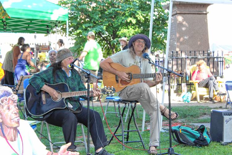 Performer Sebastian Roe took the stage right as the Stone Soup Café volunteers began serving food.