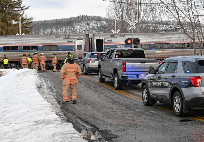 Deerfield police officers and South Deerfield fire personnel respond to the Pleasant Street railroad crossing where an adult was struck by a northbound Amtrak train on Monday afternoon. 