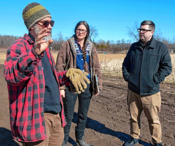 Ryan and Sarah Voiland, owners of Red Fire Farm in Granby, talks with Representative Dan Carey on Tuesday, Feb. 20, 2024, about the damage from the fire Saturday afternoon and what it will take to rebuild.