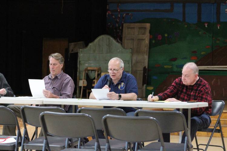 From left, Shelburne Selectboard member Andrew Baker, Town Moderator Roland Giguere and Town Clerk Joe Judd at Tuesday’s Special Town Meeting at Buckland-Shelburne Elementary School.