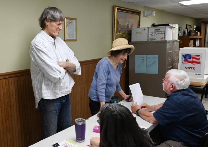 Tom and Anne Yeomans check in to vote at the Town Offices in Colrain on Tuesday.