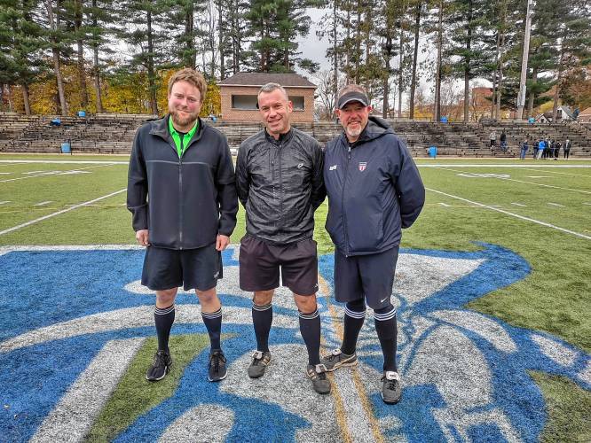 Dan Peters, center, stands between referees John Ashmore, left, and BJ Guerin at right on the soccer field. Dan Peters, center, stands between referees John Ashmore, left, and BJ Guerin at right on the soccer field.