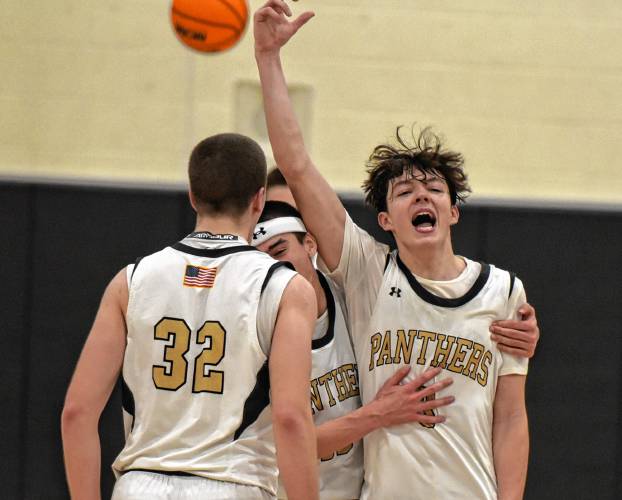 Pioneer’s Kurt Redeker (3) celebrates with teammates Josh Wood (32) and Alex McClelland after the Panthers’ 54-44 victory over Drury in the MIAA Division 5 quarterfinal round on Saturday at Messer Gymnasium in Northfield.