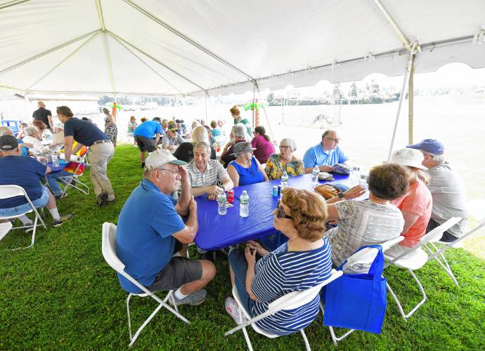Seniors chat while waiting for lunch at the South County Senior Center’s annual picnic at Herlihy Park in Whately on Wednesday.