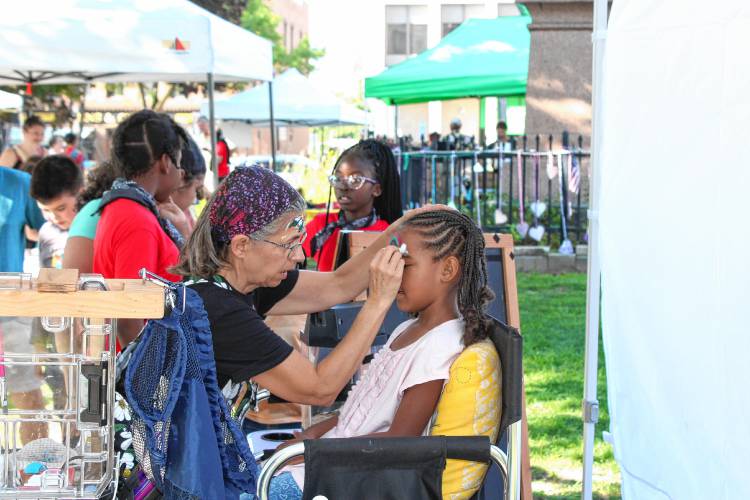 After their performance the Twice as Smart choir lined up for face painting during the Harvest Supper at Court Square.